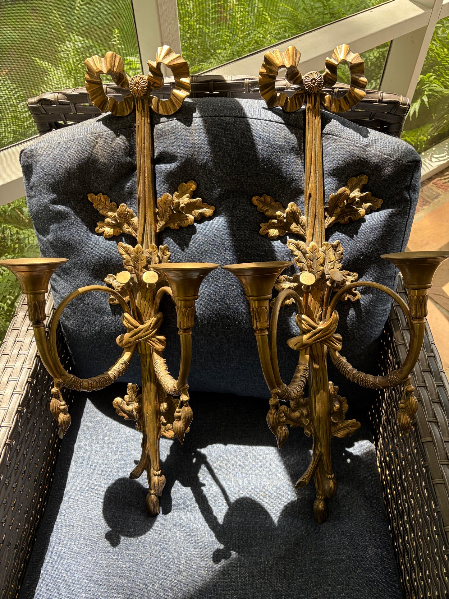 Stunning antique pair of French Louis XVI style brass wall sconces with bows, tassels, and horn motif designs!