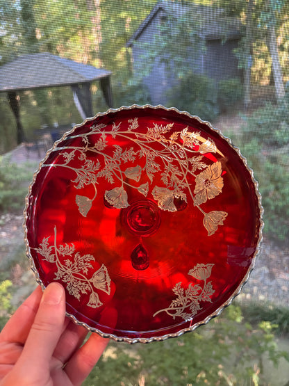 Beautiful red glass footed dish with silver florals and scalloped rim!