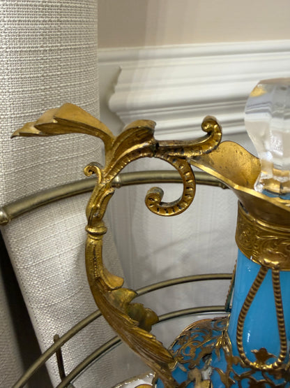 Stunning antique 19th-century French Napoleon III-style blue opaline glass ewer jugs pair adorned with elaborate gilt ormolu (gold-plated bronze) mounts, scrollwork, and scenic medallions! Circa 1836-1850