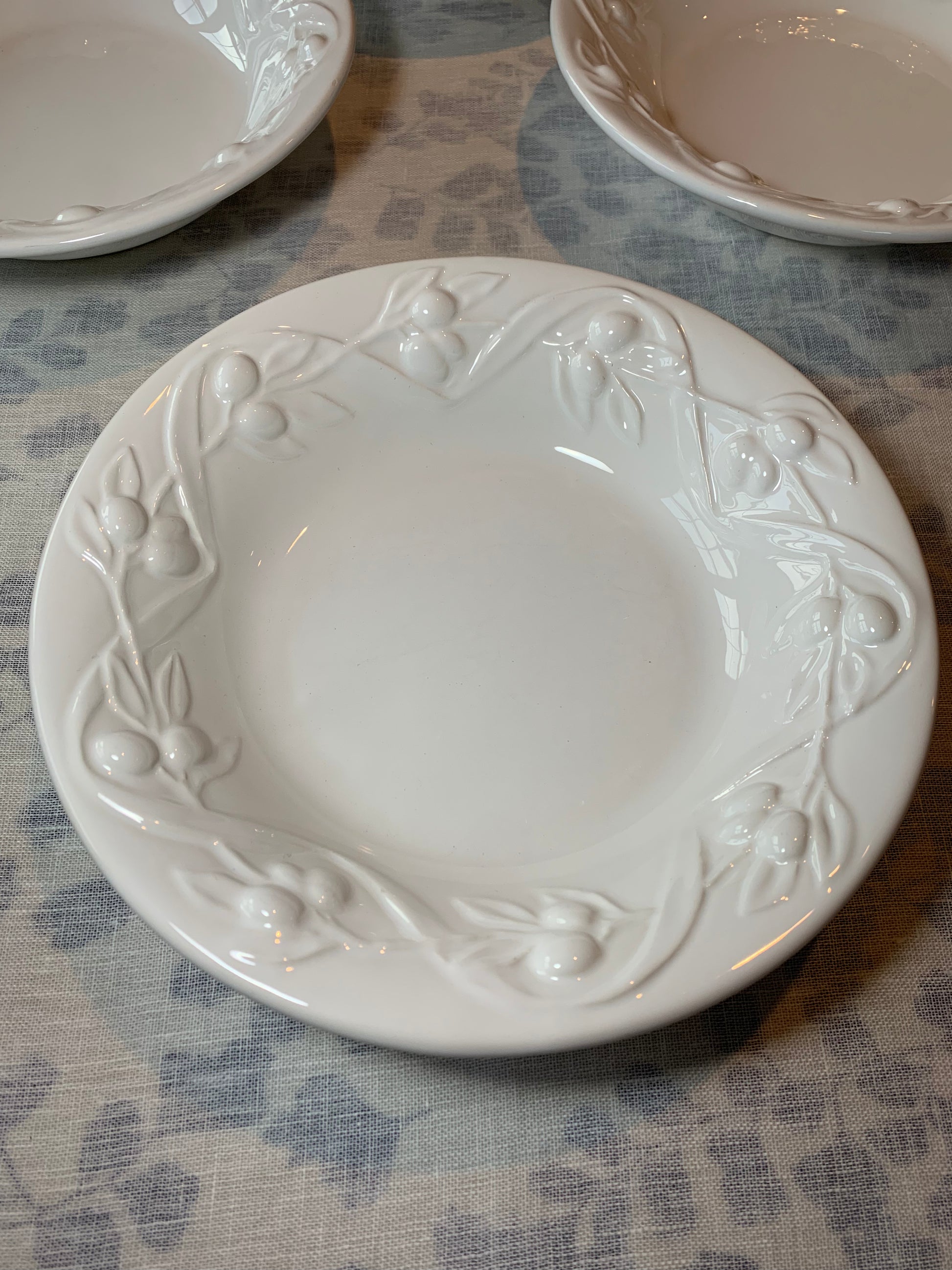 white pasta bowl with raised olive branch relief
