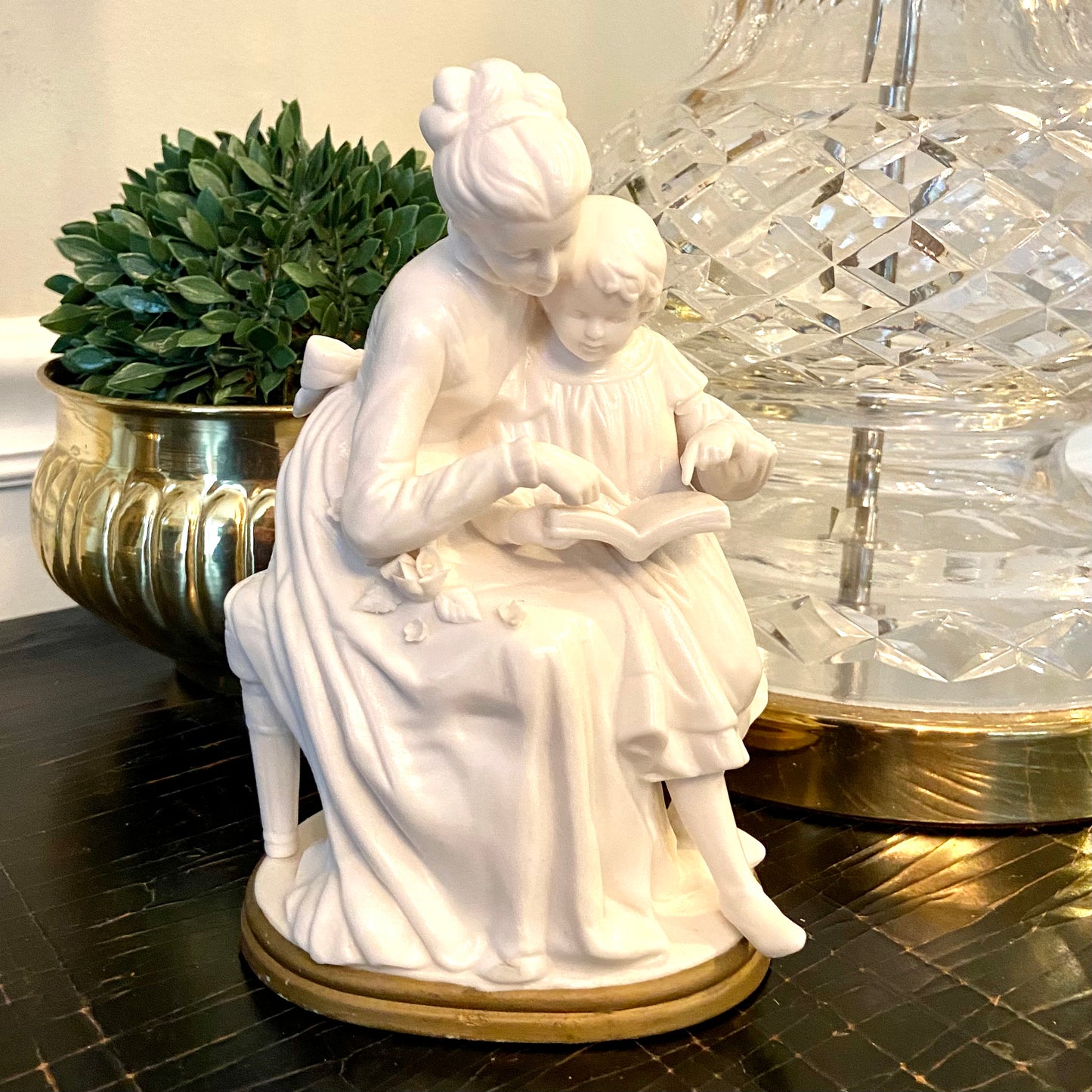Lovely vintage designer porcelains statue of mother and child reading.