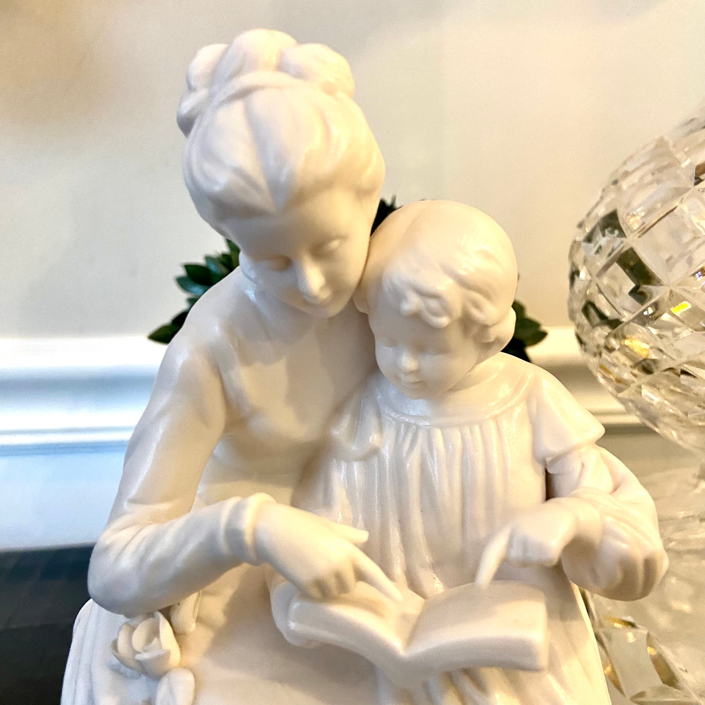 Lovely vintage designer porcelains statue of mother and child reading.