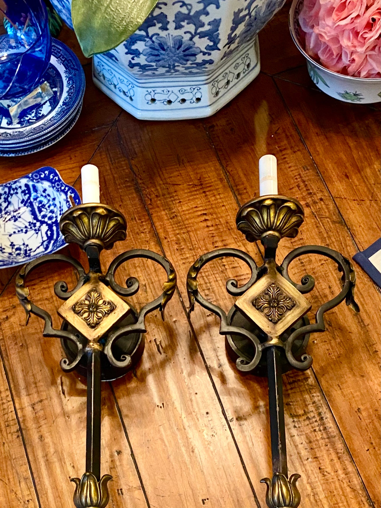 Pair of vintage ebony and gold gilt hardwired wall sconce lighting.